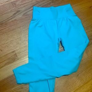 Bright blue/teal colored leggings. Size small